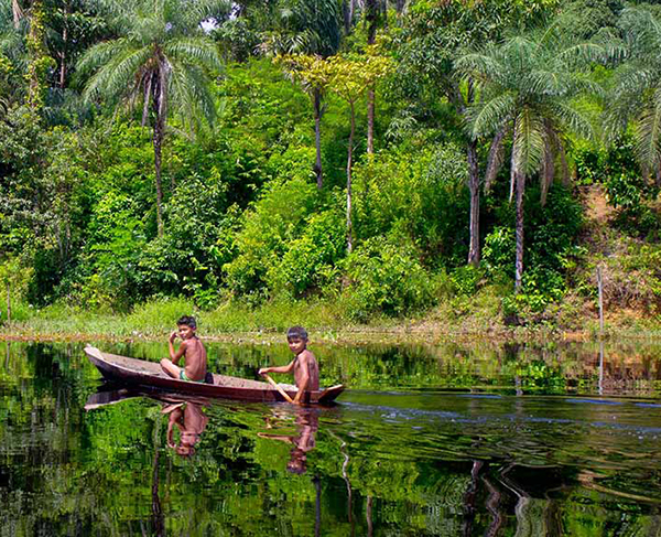 Mundukuru boys in dugout canoe on the Rio Tapajos. Image: AmazonWatch