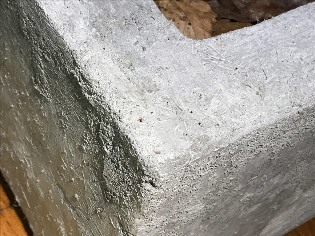 Concrete basin edge and corner detail. Every outside edge was formed in the wet cement mix with a rough 45° angle. The corners of the foam core were likewise beveled using the snap-blade cutter to leave space for this final finishing step. 