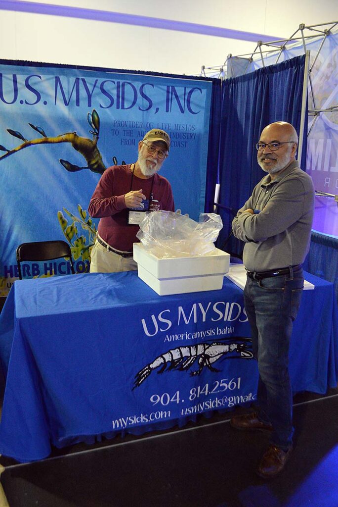 Herb Hickox (left) and Sanjay 'Photon Man' Joshi casually discuss live Mysis shrimp offerings sfrom US Mysids.
