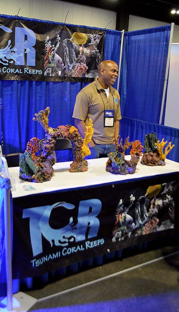 Dante Jarrett, CEO of Tsunami Coral Reefs and Aquariums, showcasing artificial coral aquascapes.